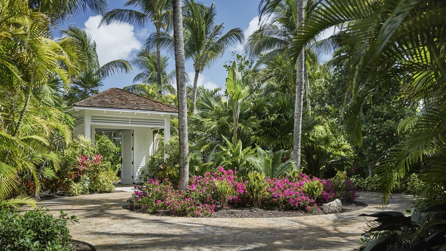 Ocean Club private villa exterior with palm trees, tropical gardens in courtyard